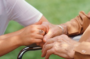 Nurse Holding Elderly Patient's Hand